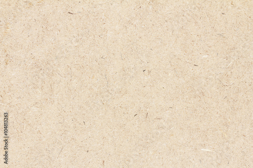 Pressed beige chipboard texture. Wooden background. photo