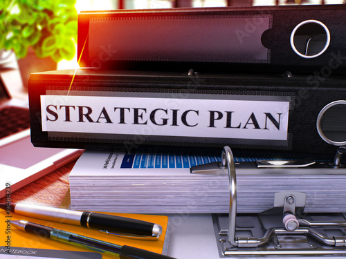 Strategic Plan - Black Ring Binder on Office Desktop with Office Supplies and Modern Laptop. Strategic Plan Business Concept on Blurred Background. Strategic Plan - Toned Illustration. 3D Render.