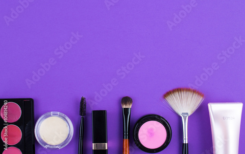 cosmetics brush lipstick shade on a purple background
