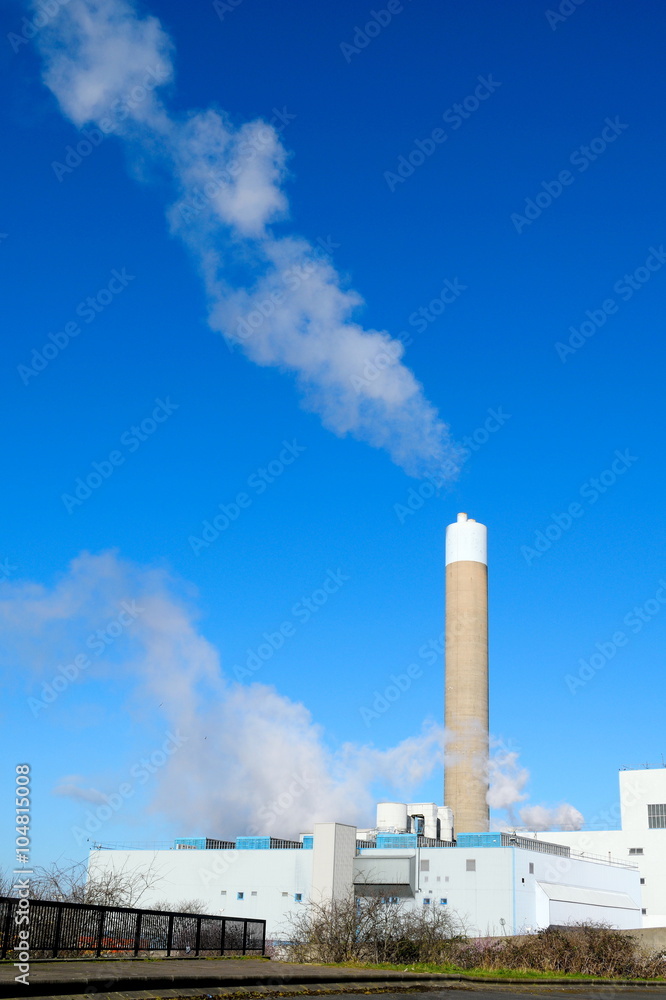 Smoke from factory against blue sky in Edmonton( North London), England Smoke from factory against blue sky in Edmonton( North London), England