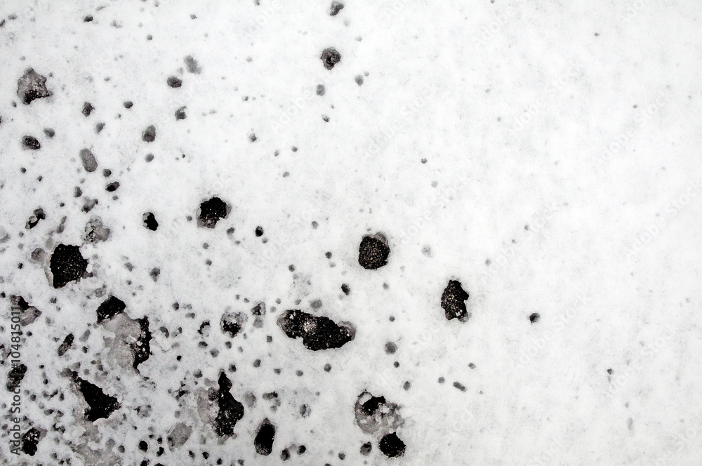Melting snow under the tree, when drops from the tree were dripping on the snow below and made a slush Melting snow under the tree, when drops from the tree were dripping on the snow below and made a slush