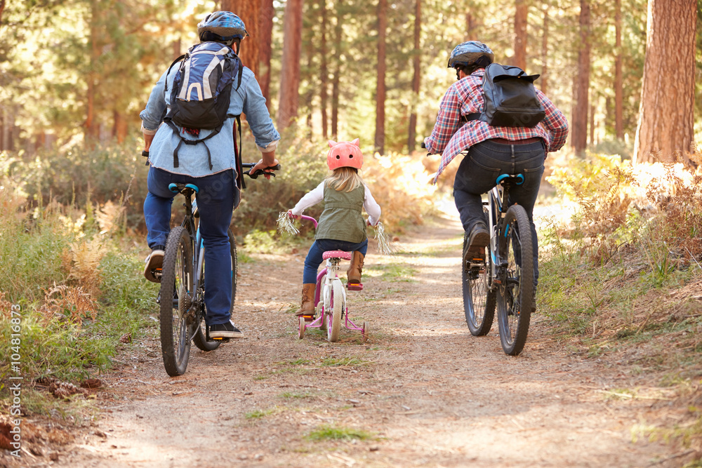 Gay Male Couple With Daughter Cycling Through Fall Woodland Gay Male Couple With Daughter Cycling Through Fall Woodland