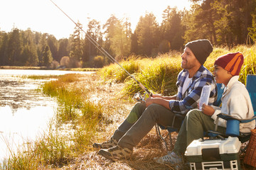 Father Teaching Son To Fish By Lake