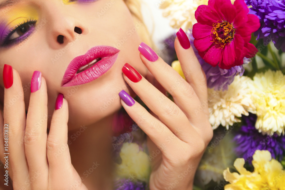 Colorful makeup and manicure with summer flowers asters on a nature background.