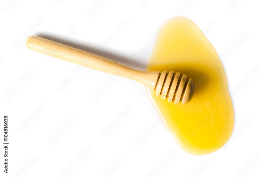 honey flowing down from a wooden stick isolated on white backgro honey flowing down from a wooden stick isolated on white backgro