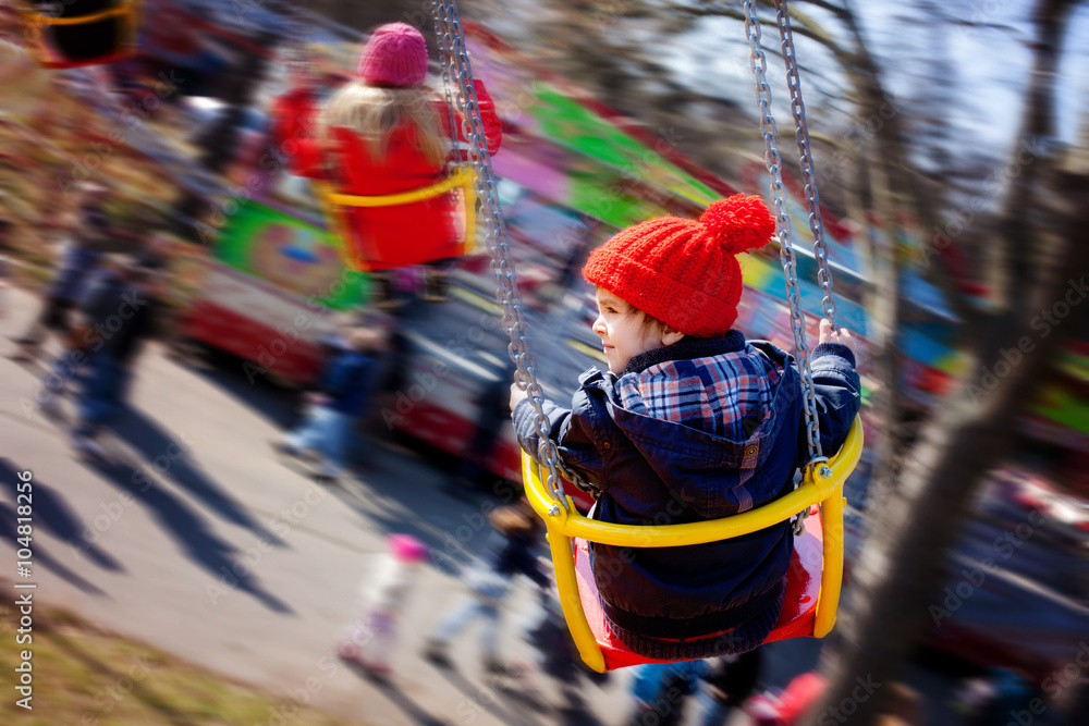 Fototapeta premium Kids, having fun on a swing chain carousel ride