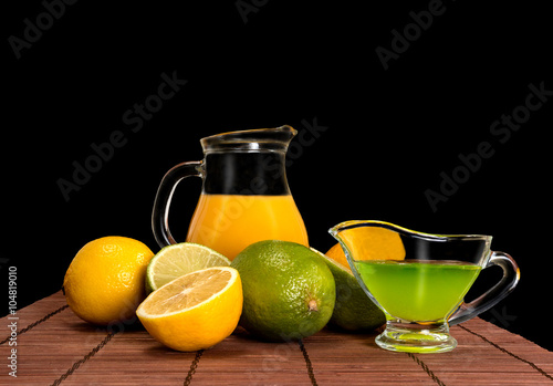 lime, lemon and pitcher of juice