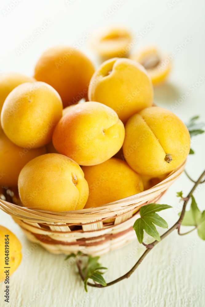 Fresh apricots in rustic basket Fresh apricots in rustic basket