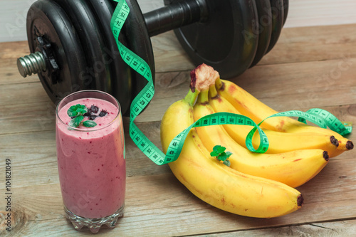 smoothies and a bunch of bananas, a dumbbell in the background