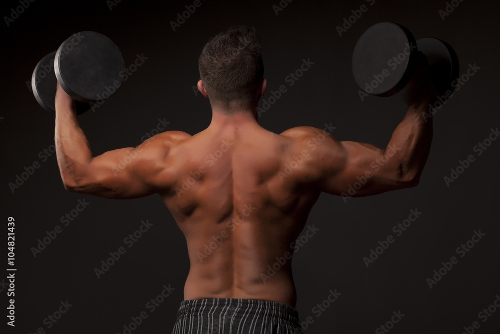 naked muscular man posing with weights naked muscular man posing with weights