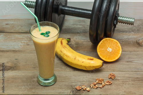 fruit smoothies and a dumbbell in the background