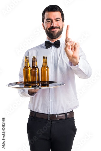 Waiter with beer bottles on the tray counting one
