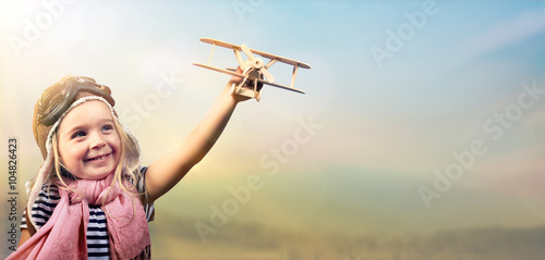 Fotografie, Tablou Freedom To Dream - Joyful Child Playing With Airplane Against The Sky