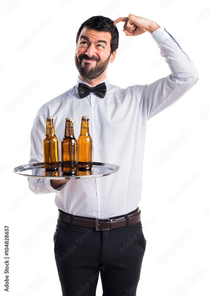 Waiter with beer bottles on the tray having doubts Waiter with beer bottles on the tray having doubts