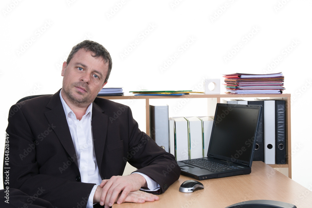 Worried businessman working at his desk in office Worried businessman working at his desk in office