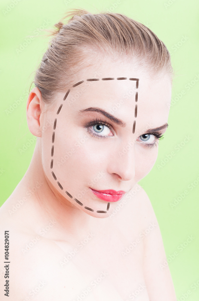 Beautiful young female face with facelift marks over green backg Beautiful young female face with facelift marks over green backg