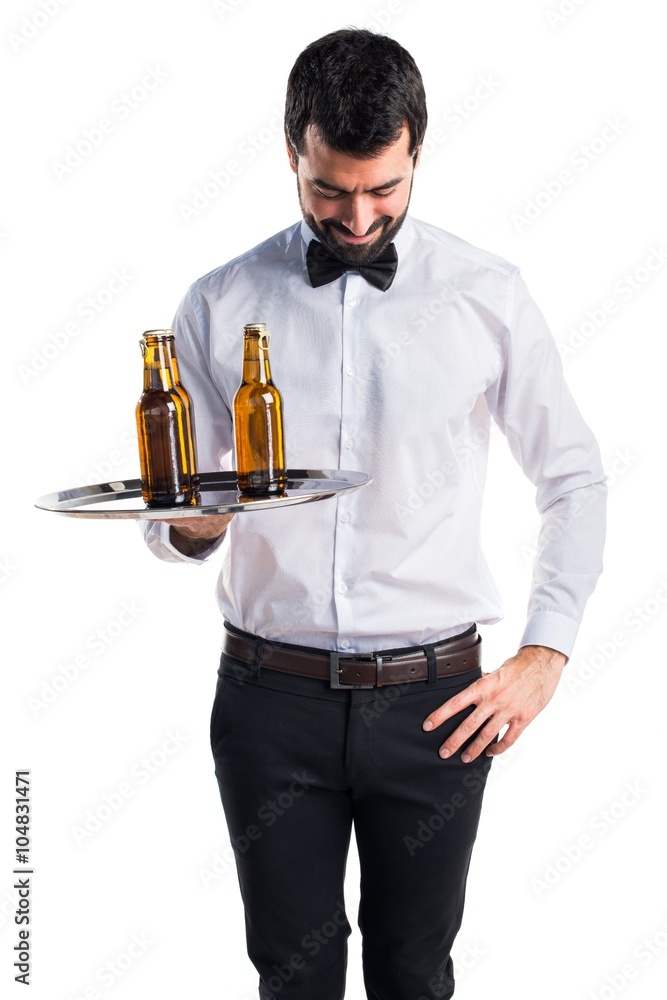 Waiter with beer bottles on the tray looking down Waiter with beer bottles on the tray looking down