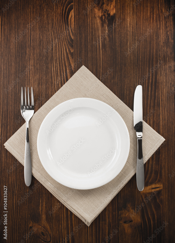 plate, knife and fork on wood plate, knife and fork on wood