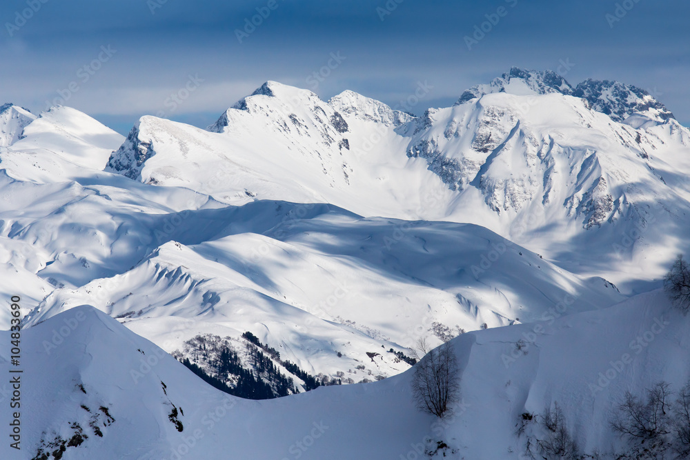 top view to Caucasian mountains covered by snow and cloud shadows top view to Caucasian mountains covered by snow and cloud shadows