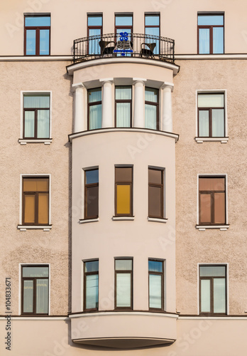 Many windows in row and bay window on facade of urban apartment building front view, St. Petersburg, Russia.