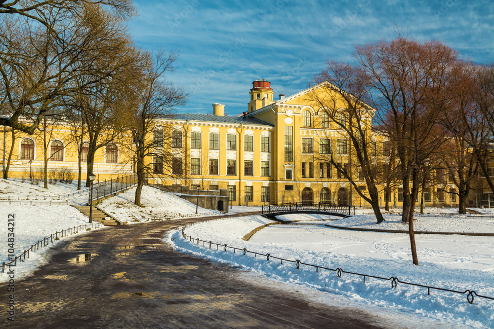 Yusupov garden and facade of Petersburg State Transport University's building in winter scene.
