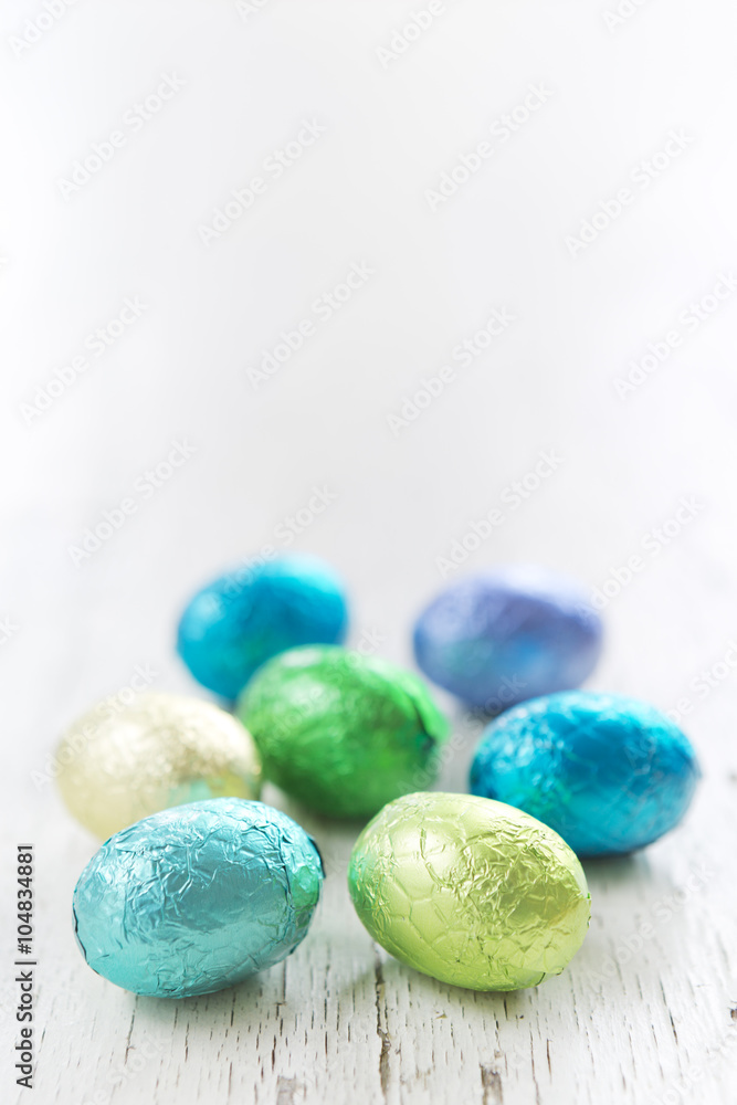Small chocolate Easter eggs on a rustic white background Small chocolate Easter eggs on a rustic white background