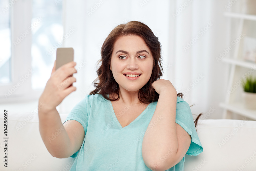 happy plus size woman with smartphone at home happy plus size woman with smartphone at home