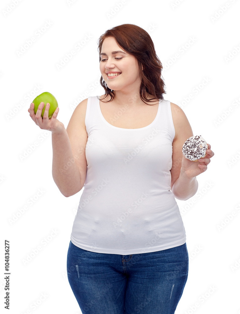happy plus size woman choosing apple or cookie happy plus size woman choosing apple or cookie