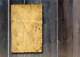 Vintage old grungy paper banner over an ancient wood texture background