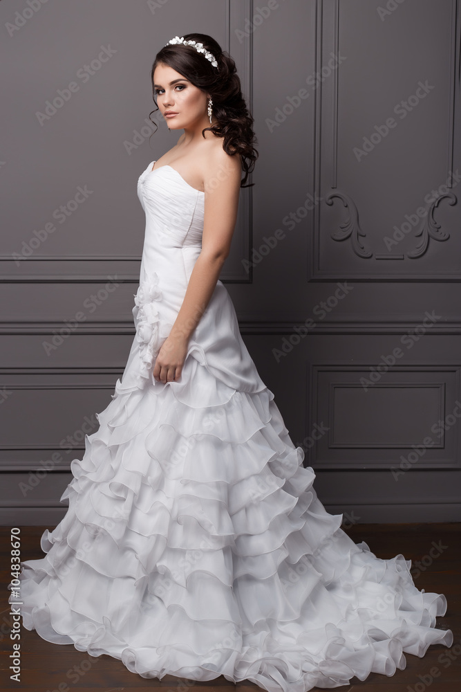beautiful gentle girl groom in a wedding dress with hairstyle and make-up,  hair decorated with a wreath of flowers Stock Photo | Adobe Stock