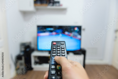 Hand holding remote control TV