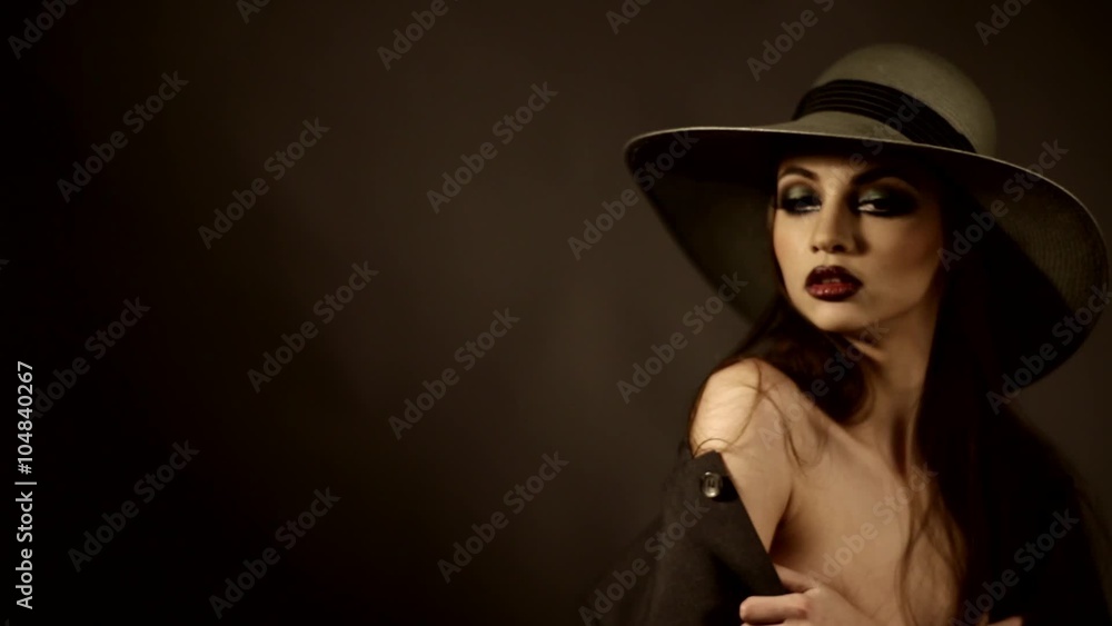 attractive girl in a hat with naked shoulders on a photo shoot in the studio attractive girl in a hat with naked shoulders on a photo shoot in the studio