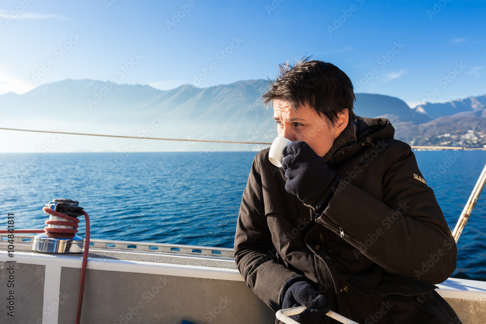 woman makes a coffee break on the sail boat