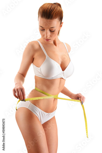 Young woman measuring herself. Weight loss