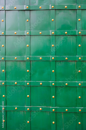 texture of green old metal door with rivets for background