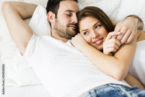 Young loving couple in the bed