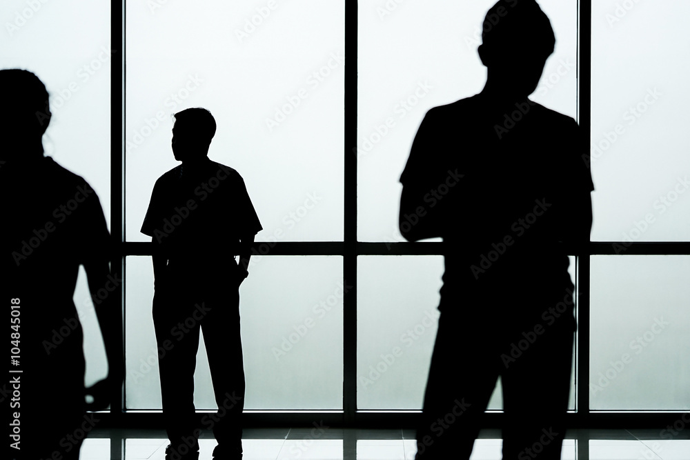 Silhouette of people in front of glass wall background, abstract image
