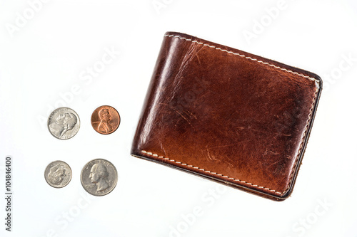 US coins spilling out of open leather wallet photo