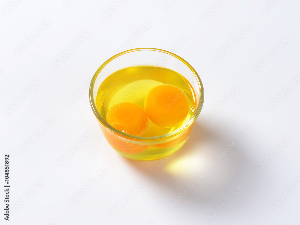 Egg whites and yolks in glass bowl Egg whites and yolks in glass bowl