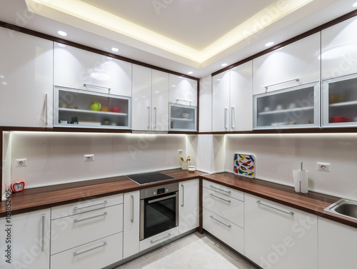 Big white kitchen in a modern apartment © poplasen