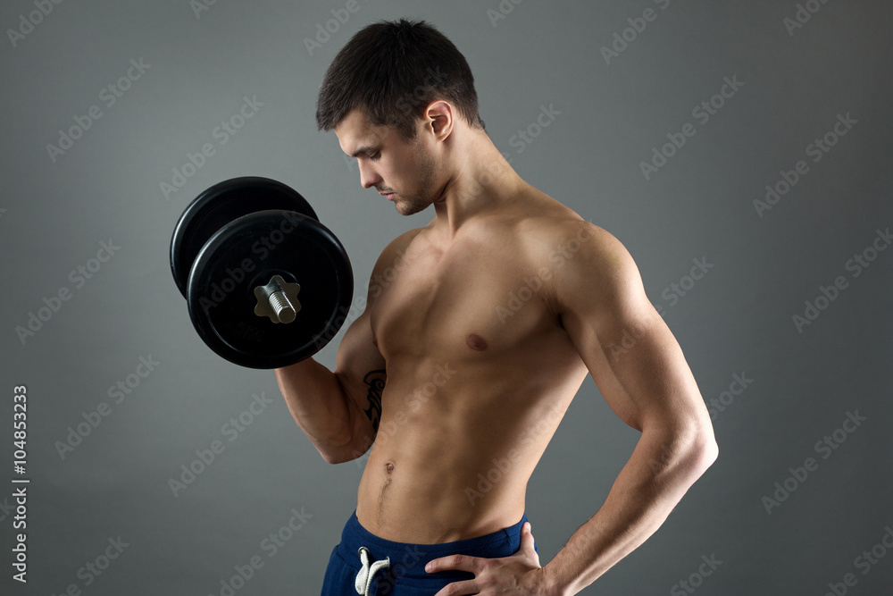 Young man with big dumbbells
