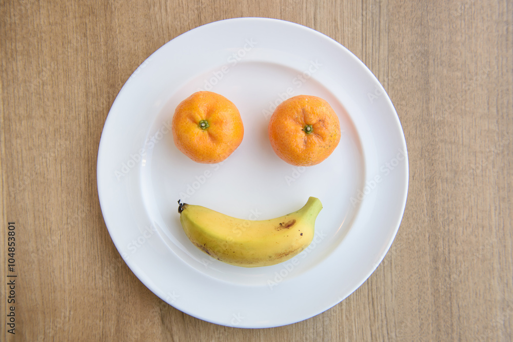 smiling face from fruits on plate