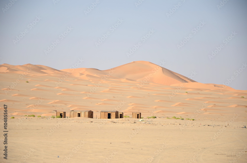 Small huts in sand dunes in desert, Oman