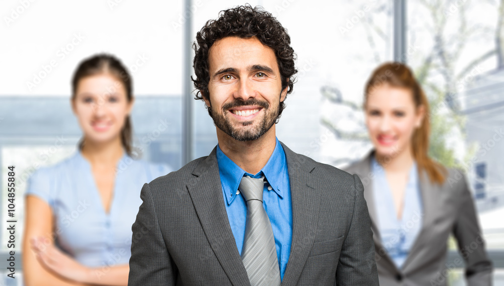 Portrait of a confident businessman in front of his team