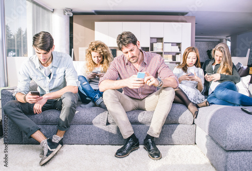 Young people looking down at cellular phone