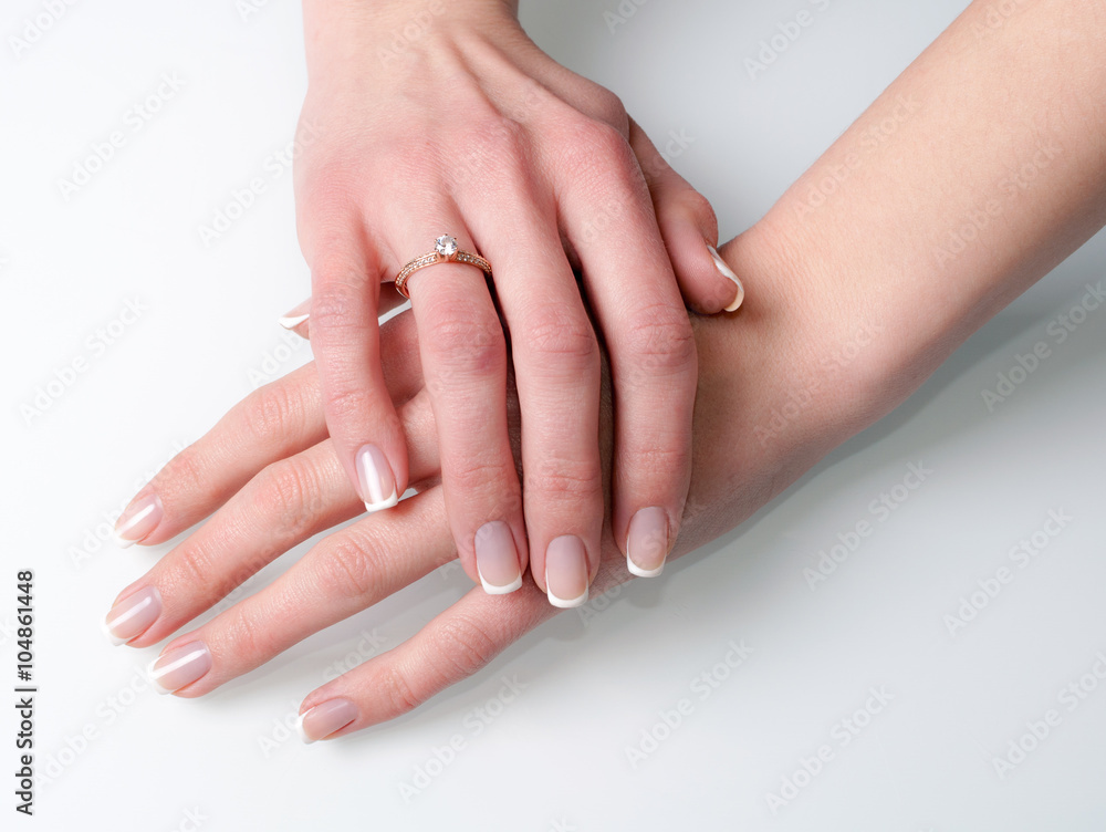 Woman hands with engagement ring on white Woman hands with engagement ring on white