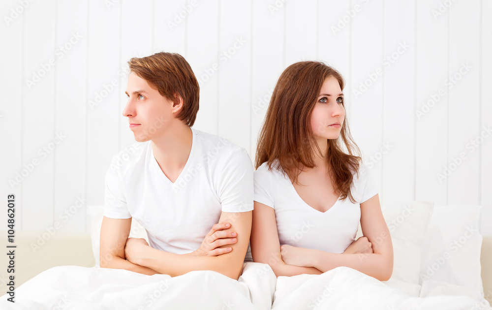 Upset couple having marital problems or a disagreement in bed Upset couple having marital problems or a disagreement in bed