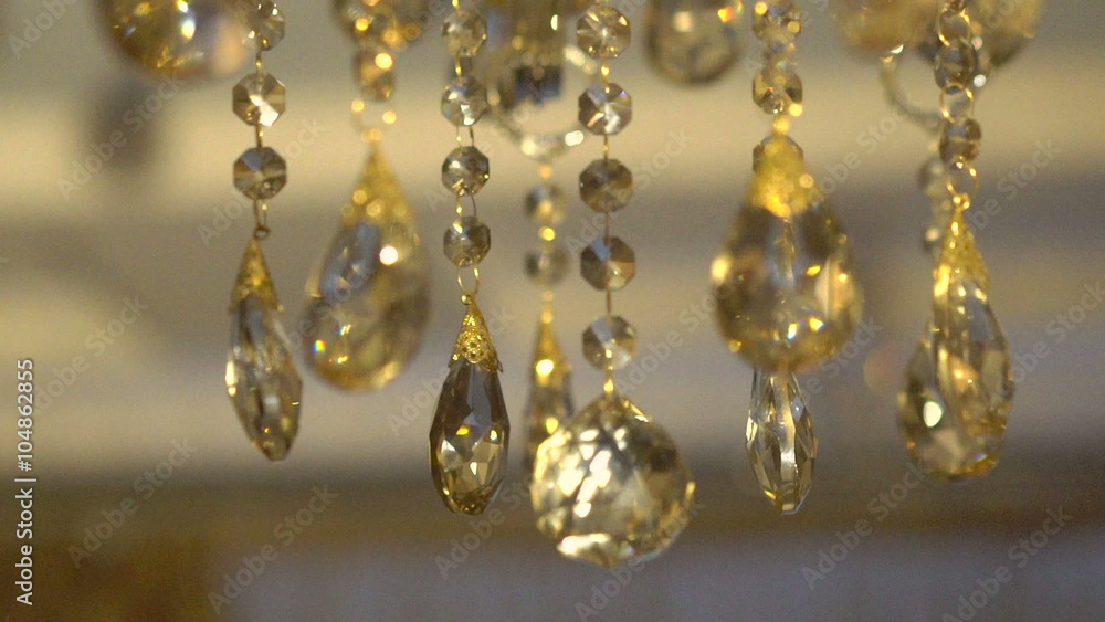 Moving of a bright crystal chandelier on a dark background. Slowly Moving of a bright crystal chandelier on a dark background. Slowly