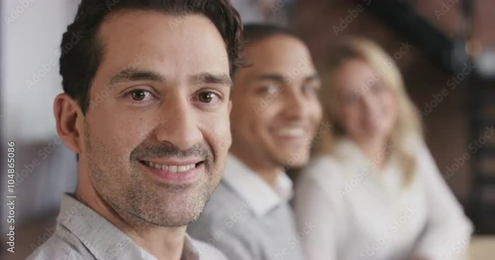 Portrait of a confident young business woman at boardroom table in trendy modern shared office space a diverse team chatting together slow motion turning around smiling Portrait of a confident young business woman at boardroom table in trendy modern shared office space a diverse team chatting together slow motion turning around smiling