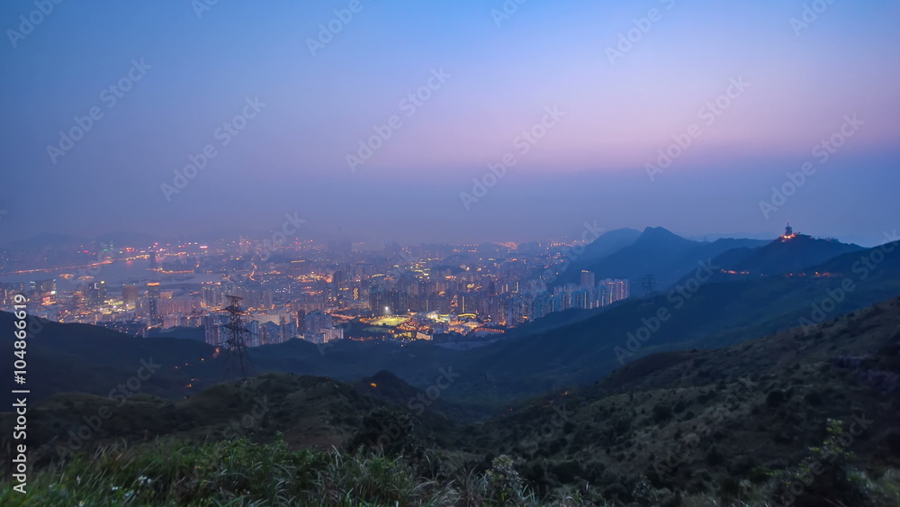 Cityscape of Hong Kong as viewed atop Kowloon Peak with day to night timelapse with Hong kong and Kowloon below Cityscape of Hong Kong as viewed atop Kowloon Peak with day to night timelapse with Hong kong and Kowloon below